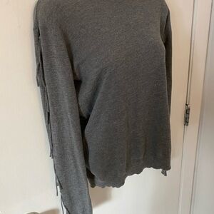 Candela light grey sweater with fringe ties down the sleeves